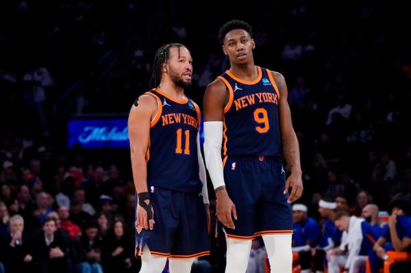 Jalen Brunson (11) and RJ Barrett (9) co<em></em>nverse during the second half of an NBA basketball game against the Phoenix Suns