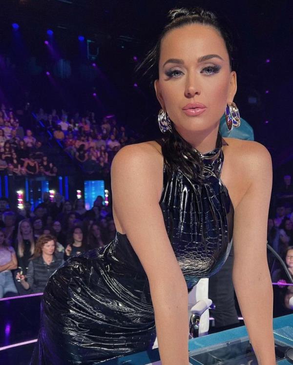 Katy Perry standing in a shiny dress at 