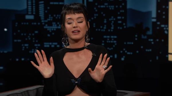 Katy Perry with her hands up while talking in an interview.