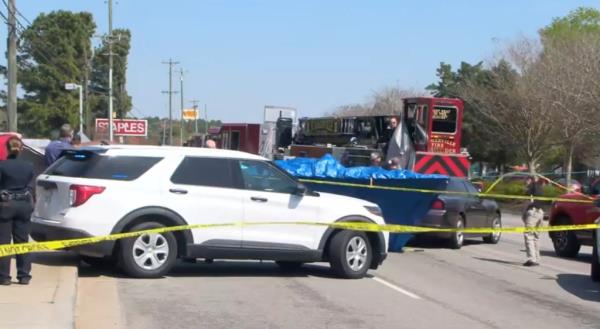 Police tape around a white car