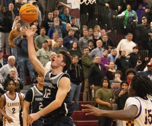 Mansquan's Griffin Linstra puts in a game winning shot at the buzzer that was later called off by the referees.