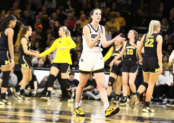  Caitlin Clark #22 of the Iowa Hawkeyes walks off the court after breaking the NCAA women's all-time scoring record