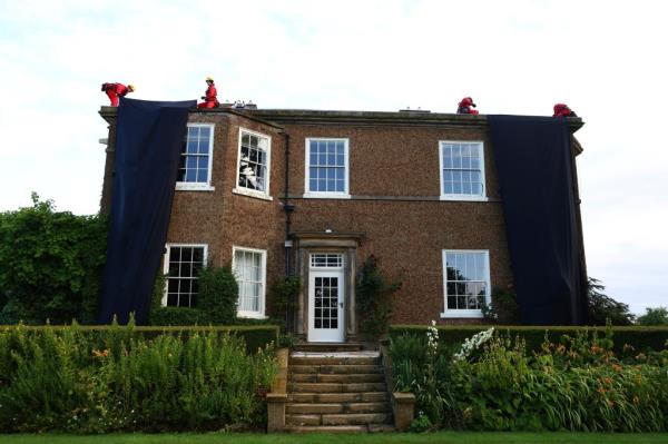 Activists climb o<em></em>nto the roof of the manor house of Britain's Prime Minister Rishi Sunak in Yorkshire, England, on Aug. 3, 2023. 