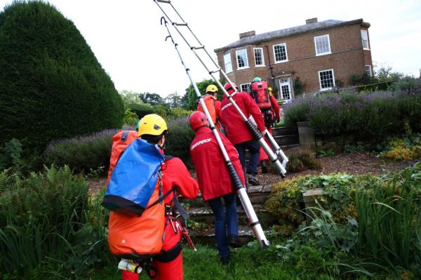 Greenpeace activists are captured arriving at the manor house with ladders and other equipment in Yorkshire, England, on Aug. 3, 2023. 