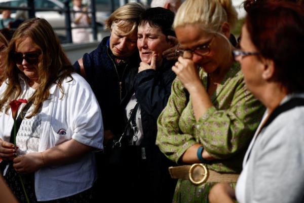 People react as fans gather outside late Irish singer Sinead O'Connor's former home to say their last goodbye 