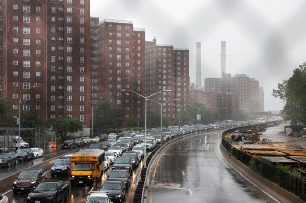 Cars sit on a road as the remnants of Tropical Storm Ophelia bring flooding across the mid-Atlantic and Northeast.