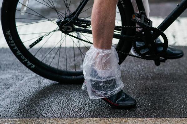 A person wears a rain shoe cover during a coastal storm in Lower Manhattan on Friday.