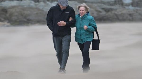 Mandatory Credit: Photo by Martin Dalton/Shutterstock (14128995l) A couple walk across the sands whipped up Storm Agnes as it blows across Woolacombe bay North Devon. Storm Agnes, Devon, North Devon, Woolacombe Bay, UK - 27 Sep 2023