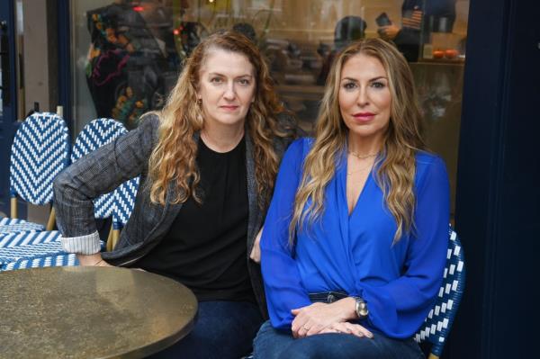 Parents Maud Maron and Yael Denbo pose outside Greenwich Village School.