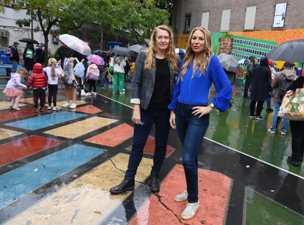 Manhattan parents Maud Maron and Yael Denbo pose in front of PS 41.