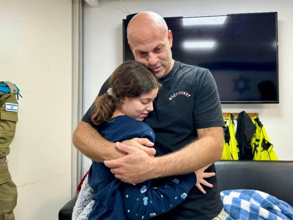 In this photo provided by the Israeli Army, Hila Rotem Shoshani, a released hostage, reunites with her uncle Sunday, Nov. 26, 2023, in Israel.