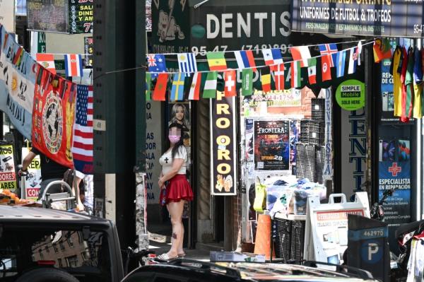 Women outside a suspected sex shop on Roosevelt Ave.