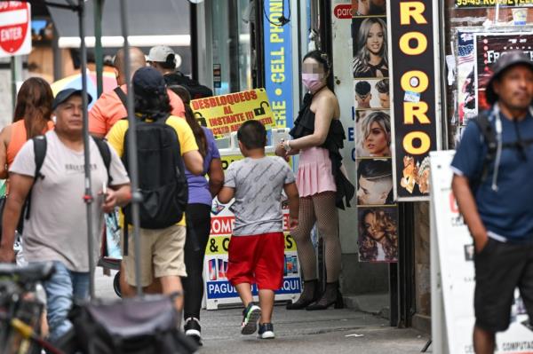 Women outside a suspected sex shop on Roosevelt Ave.