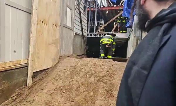 Firefighters inspect the site of the building collapse.