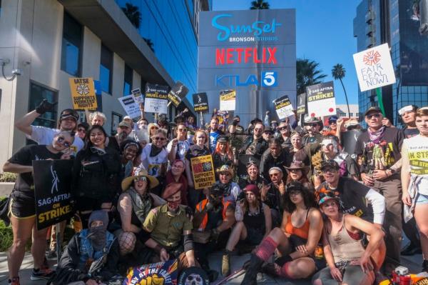 Striking SAG-AFTRA members walk with pickets outside Netflix studios, Wednesday, November 8, 2023, in Los Angeles