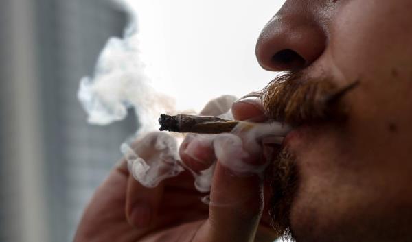 Photo of a man smoking a joint. 