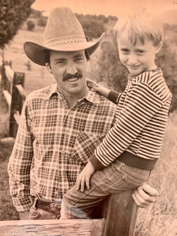 Eli Stutzman, in cowboy hat, holds son Danny Stutzman, around age 9. 