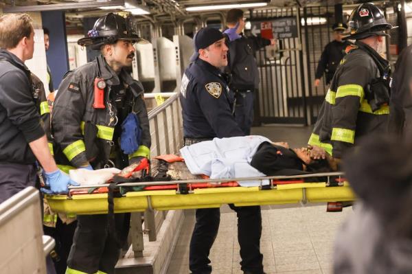 FDNY rescuers pull woman out of subway.