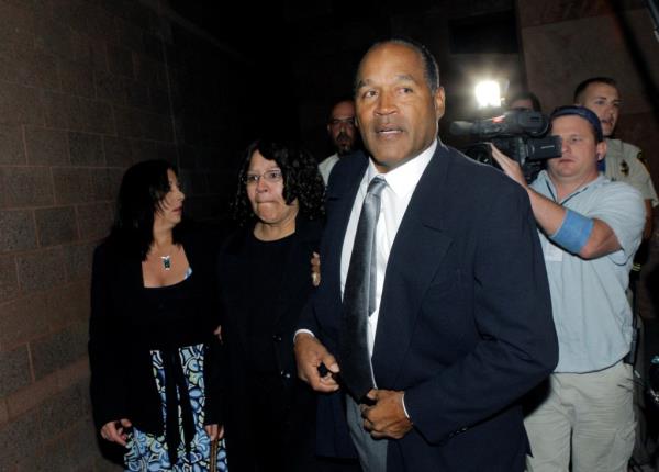 A rep for Simpson's estate said the former football player's brain won't be do<em></em>nated to scientists studying CTE. Simpson seen here in a suit and tie with a tv camera behind him