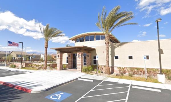 A building of Palm Southwest Mortuary with palm trees and a parking lot in Las Vegas, NV