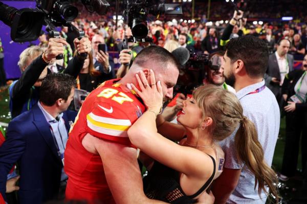 Travis Kelce and girlfriend Taylor Swift share an embrace after Kelce's Chiefs won Super Bowl LVIII in Las Vegas.