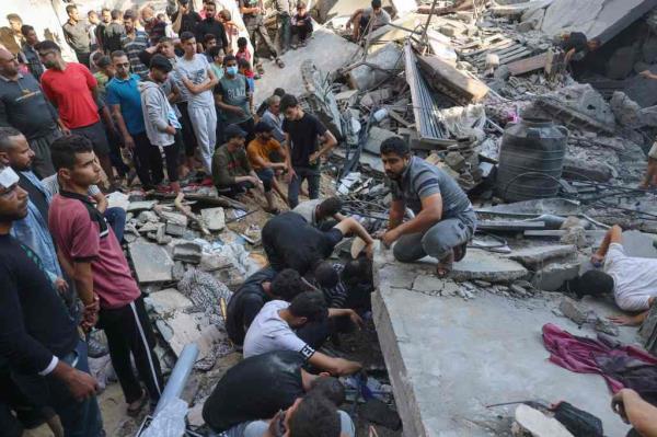 Palestinians look for survivors in the rubble of a building following Israeli bombing in Rafah in the southern Gaza Strip, on Oct. 31, 2023. 