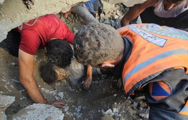 Palestinians work on the rescue of a casualty at the site of Israeli strikes on houses in Jabalia refugee camp in the northern Gaza Strip, on Oct. 31, 2023. 