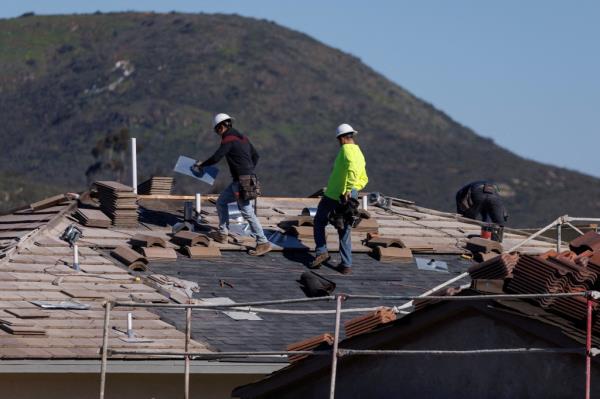 Co<em></em>nstruction workers at a home