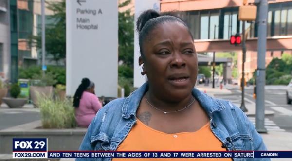 Woman in blue jean jacket expressing grief over the loss of her two children in a pool drowning incident