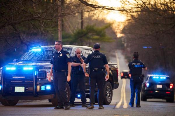 Law enforcement officers guard a road leading to the home of Massachusetts Air Natio<em></em>nal Guardsman Jack Teixeira on Thursday, April 13, 2023 in North Dighton, Massachusetts.