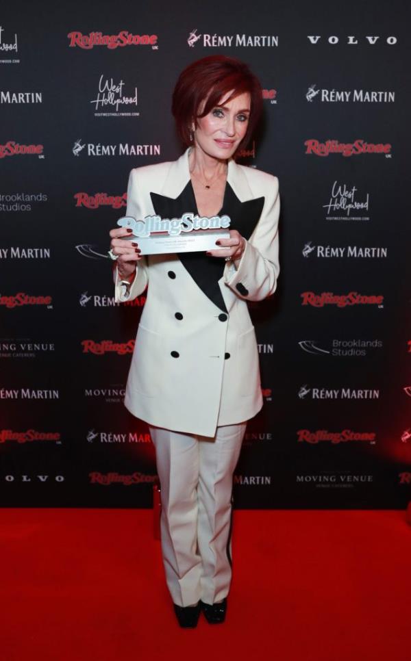 Sharon Osbourne holds up an award.