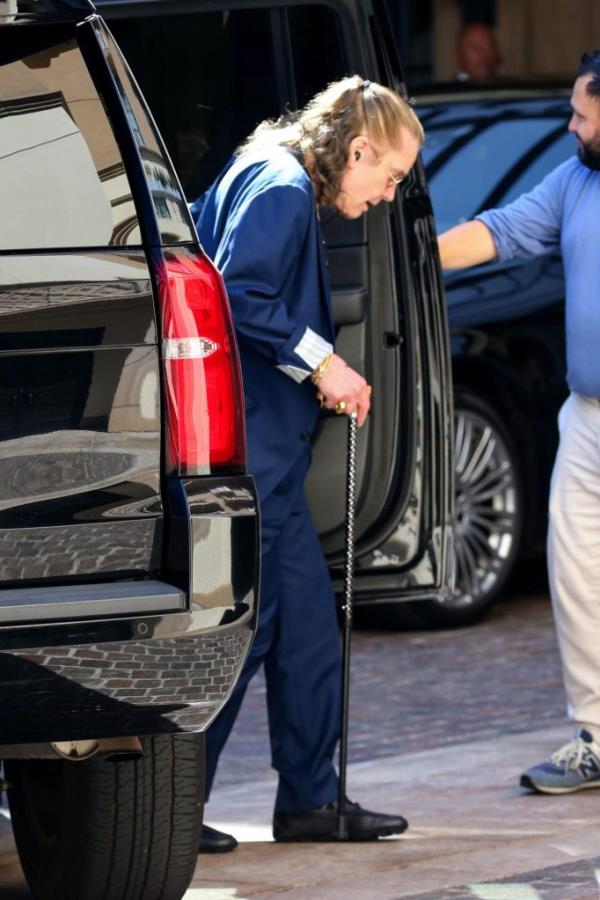 Ozzy Osbourne walks with a cane.