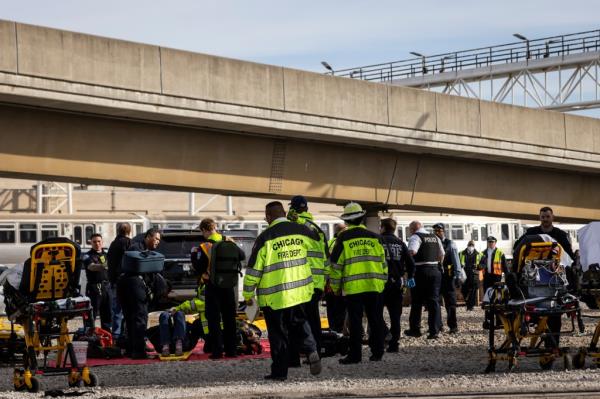 First respo<em></em>nders at the scene of wher<em></em>e a commuter train crashed into rail equipment in Chicago on Nov. 16, 2023.