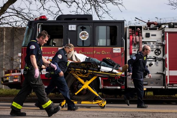 First respo<em></em>nders transporting one of the injured passengers to an ambulance.