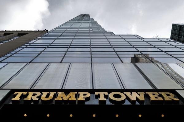 Trump Tower located on Fifth avenue in NYC, a tall building with a tall glass wall.