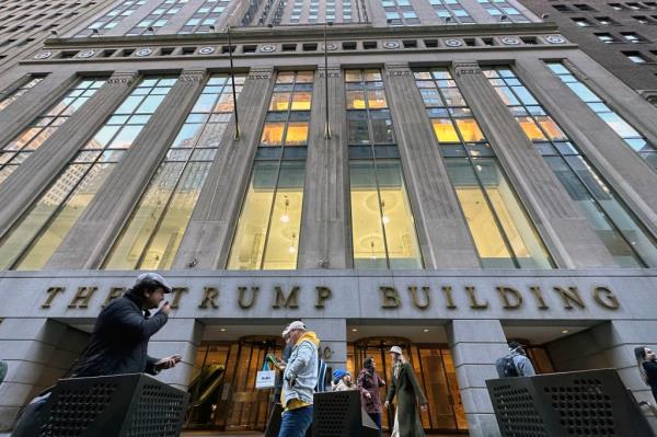 People walk by The Trump Building office building at 40 Wall Street in New York City, Friday, Nov. 3, 2023.