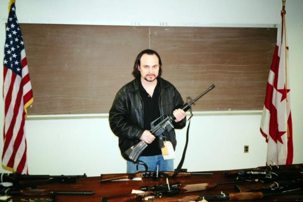 Dale Sutherland holds a rifle.