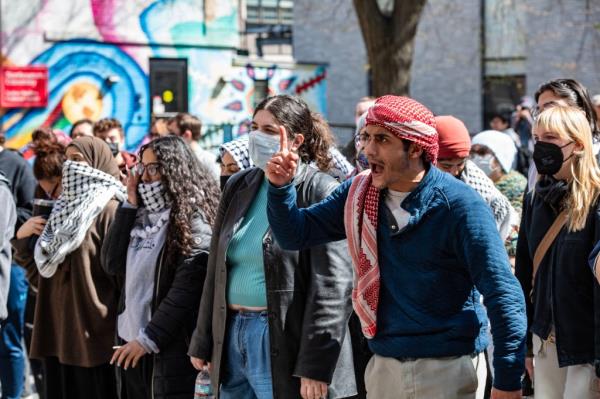 Anti-Israel protesters standing in front of a police barricade at Northeastern University in Boston on April 27, 2024.