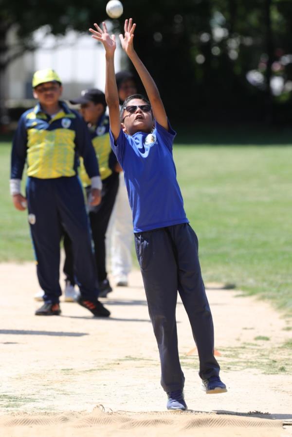 Senush Jayakody, 9, reaches to make a catch during Saturday's youth cricket clinic.