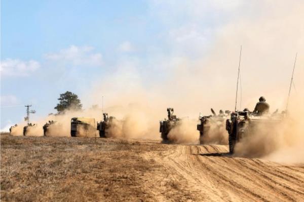 Israeli army tanks and vehicles deploy along the border with the Gaza Strip in southern Israel on October 13, 2023. Thousands of people, both Israeli and Palestinians have died since October 7, 2023, after Palestinian Hamas militants entered Israel in a surprise attack leading Israel to declare war on Hamas in the Gaza Strip enclave on October 8. (Photo by JACK GUEZ / AFP) (Photo by JACK GUEZ/AFP via Getty Images)