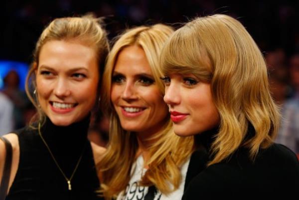 NEW YORK, NY - OCTOBER 29: (NEW YORK DAILIES OUT) Singer Taylor Swift (R) attends a game between the New York Knicks and the Chicago Bulls with models Heidi Klum (C) and Karlie Kloss at Madison Square Garden on October 29, 2014 in New York City. The Bulls defeated the Knicks 104-80. NOTE TO USER: User expressly acknowledges and agrees that, by downloading and/or using this Photograph, user is co<em></em>nsenting to the terms and co<em></em>nditions of the Getty Images License Agreement. (Photo by Jim McIsaac/Getty Images)