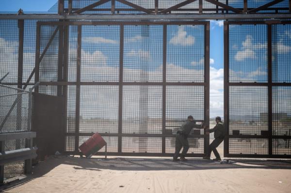 Border Patrol close a gate in the border wall