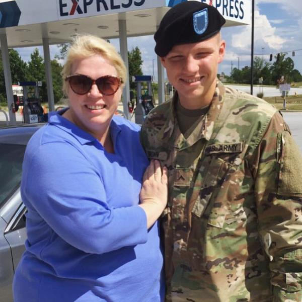 A soldier's heart held by a woman.