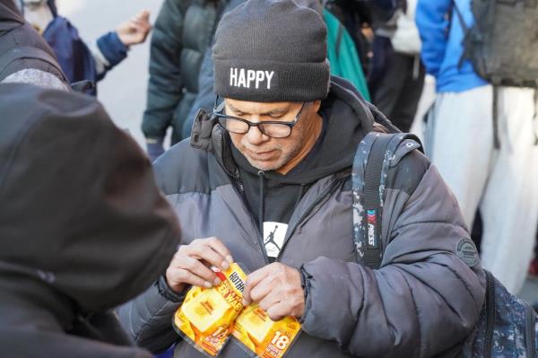 Migrants, speaking mostly French, waiting on line