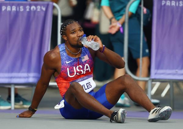 Noah Lyles of United States reacts after winning bro<em></em>nze before receiving medical attention 