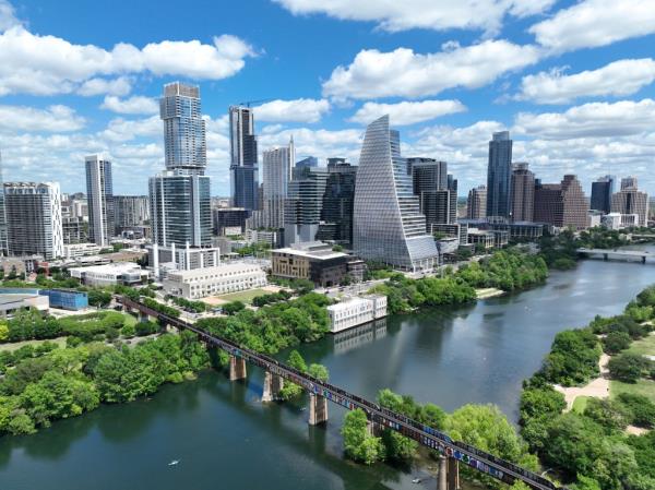 Aerial view of the downtown skyline of Austin, Texas with a bridge over a river, illustrating its ranking as the top U.S job market