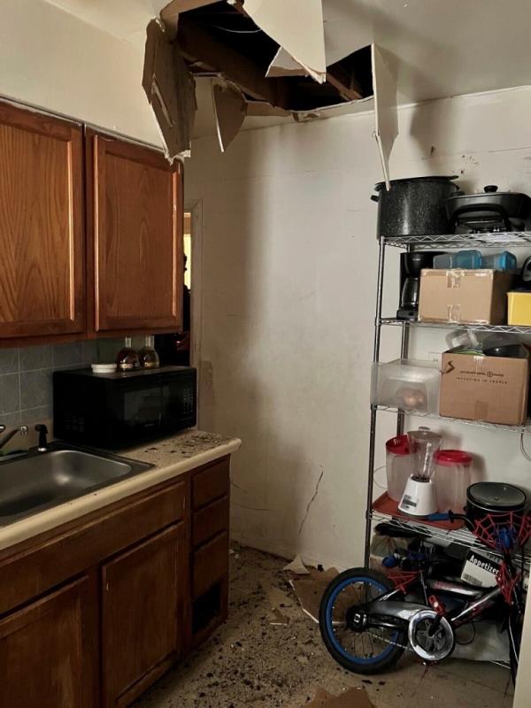 The kitchen with a hole in the ceiling. 