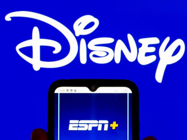 ESPN+ logo displayed on a smartphone screen with the Disney logo in the background