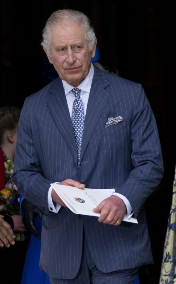 King Charles III in a suit, holding a piece of paper, at the 2023 Commo<em></em>nwealth Day Service at Westminster Abbey, London.