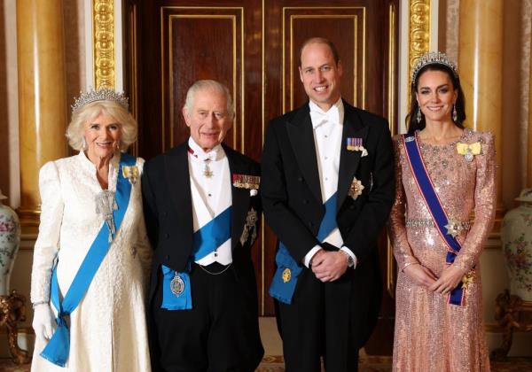 King Charles III, Queen Camilla, Prince William, and Catherine posing for a photo at the Diplomatic Reception in the 1844 Room at Buckingham Palace